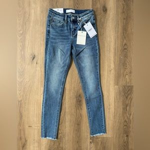 Mid Rise Raw Hem Ankle Jeans.